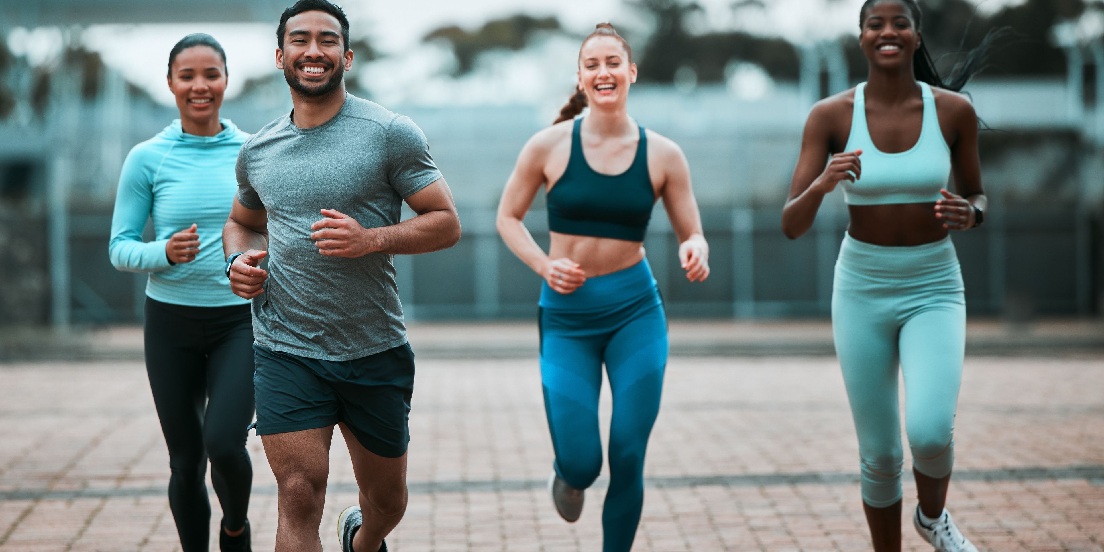 Four people running in sportswear.
