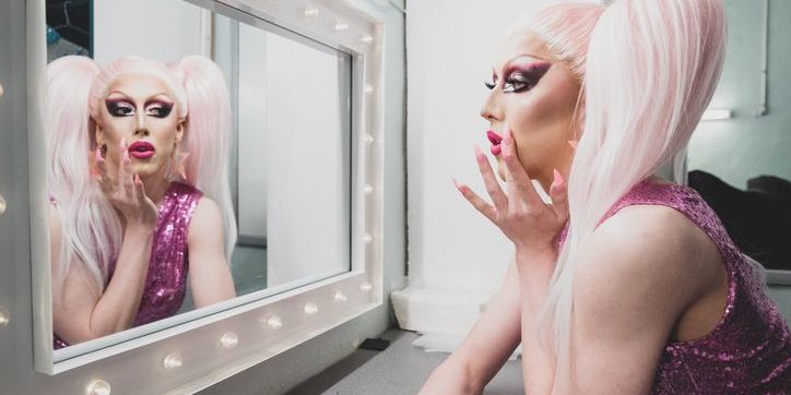 A drag performer getting ready backstage.