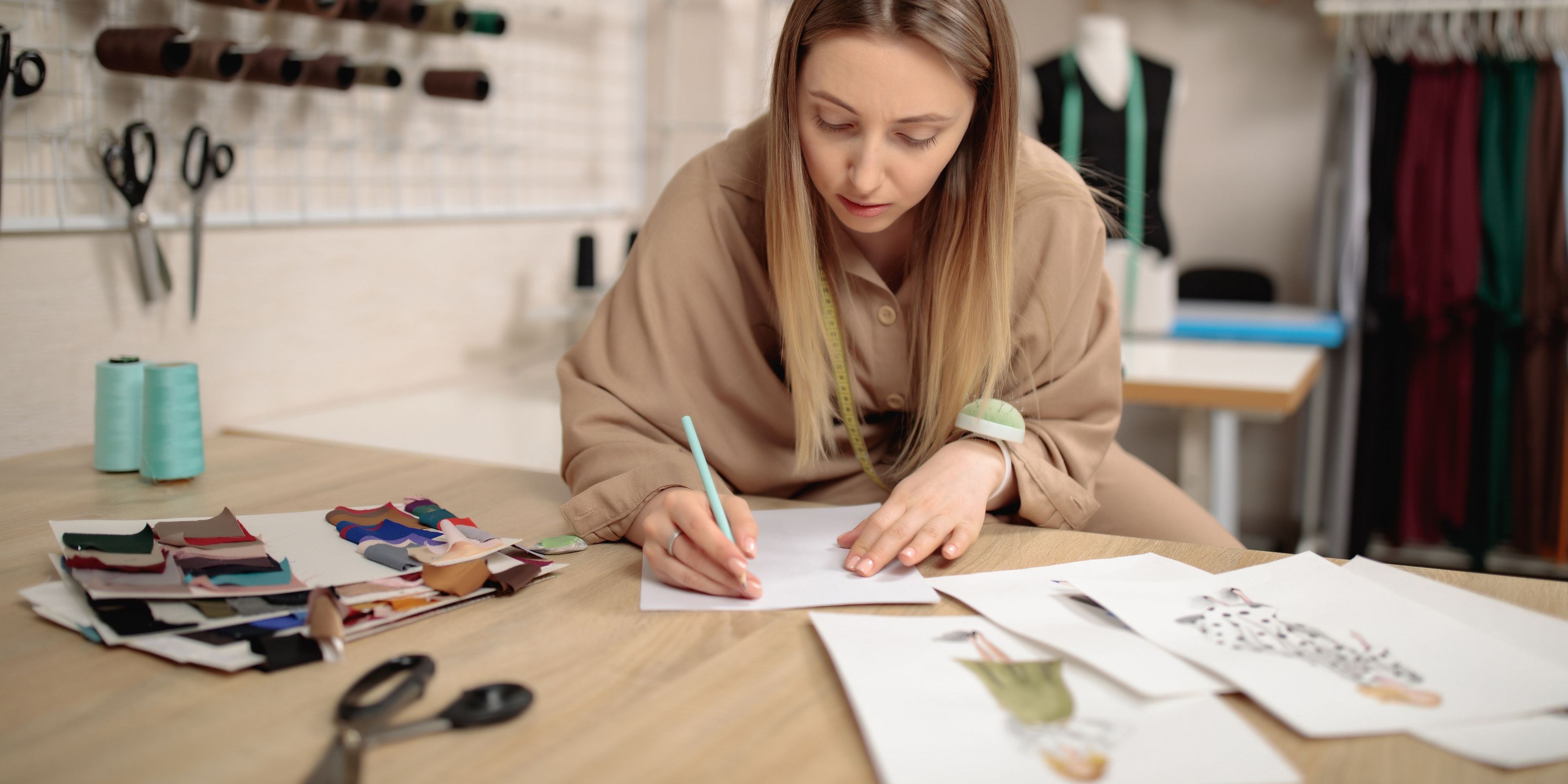 A fashion illustrator sketching designs.