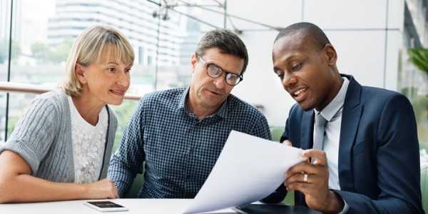 A financial advisor going over investment options with a couple.