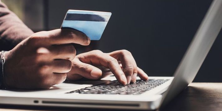 A man making an online purchase with his credit card.