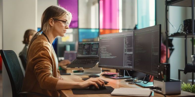 A Robo-advisor developer working on her computer.