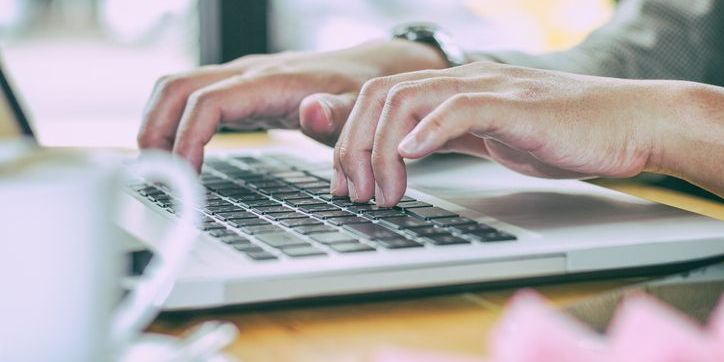 An educational content creator working on his computer.