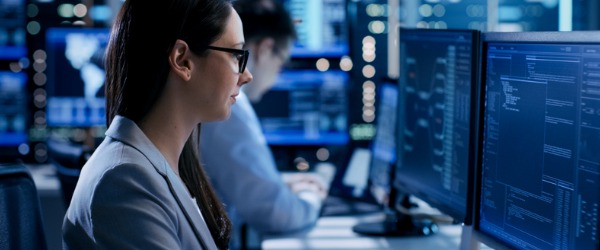 A security architect working on  her computer.