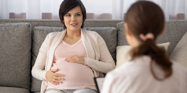 A midwife having a discussion with a client.