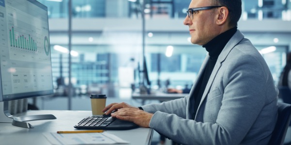 A portfolio manager working at his desk.