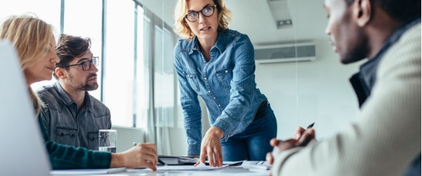 A project manager having a meeting with her project team.